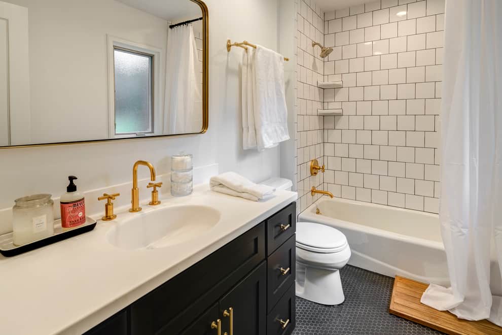 Contemporary bathroom, white tile walls, black floor and cabinets