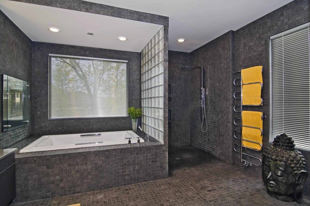 Omni-tile open shower with glass wall